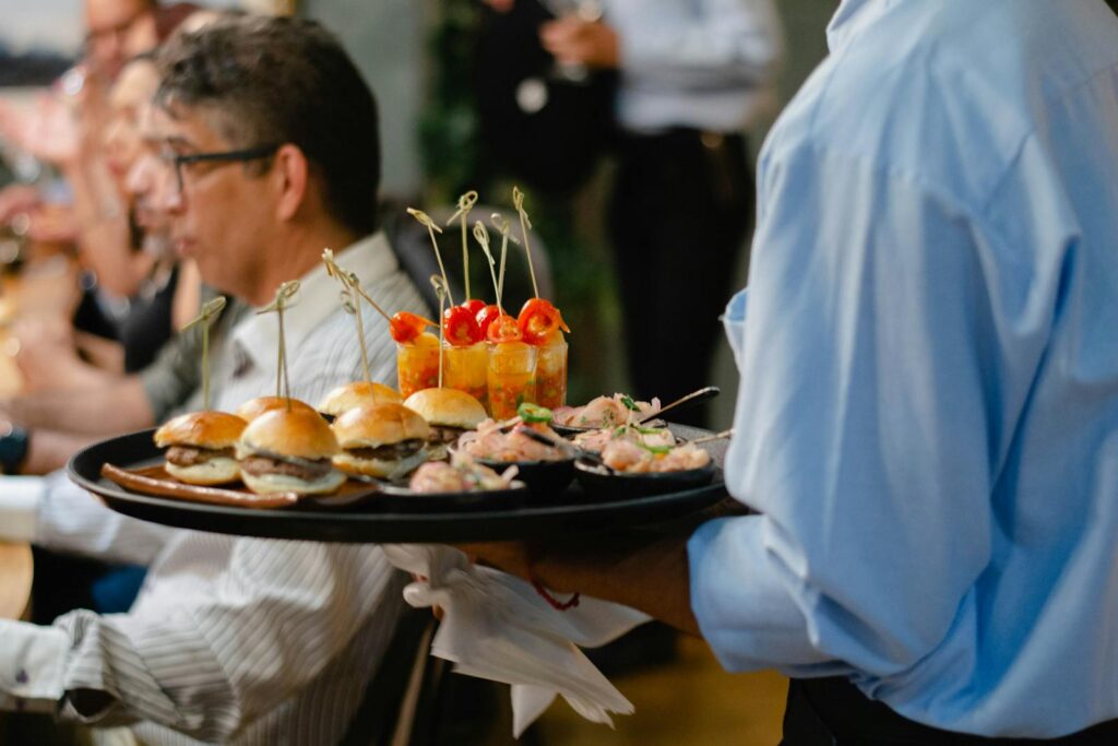 Waiter Carrying Tray with Snacks